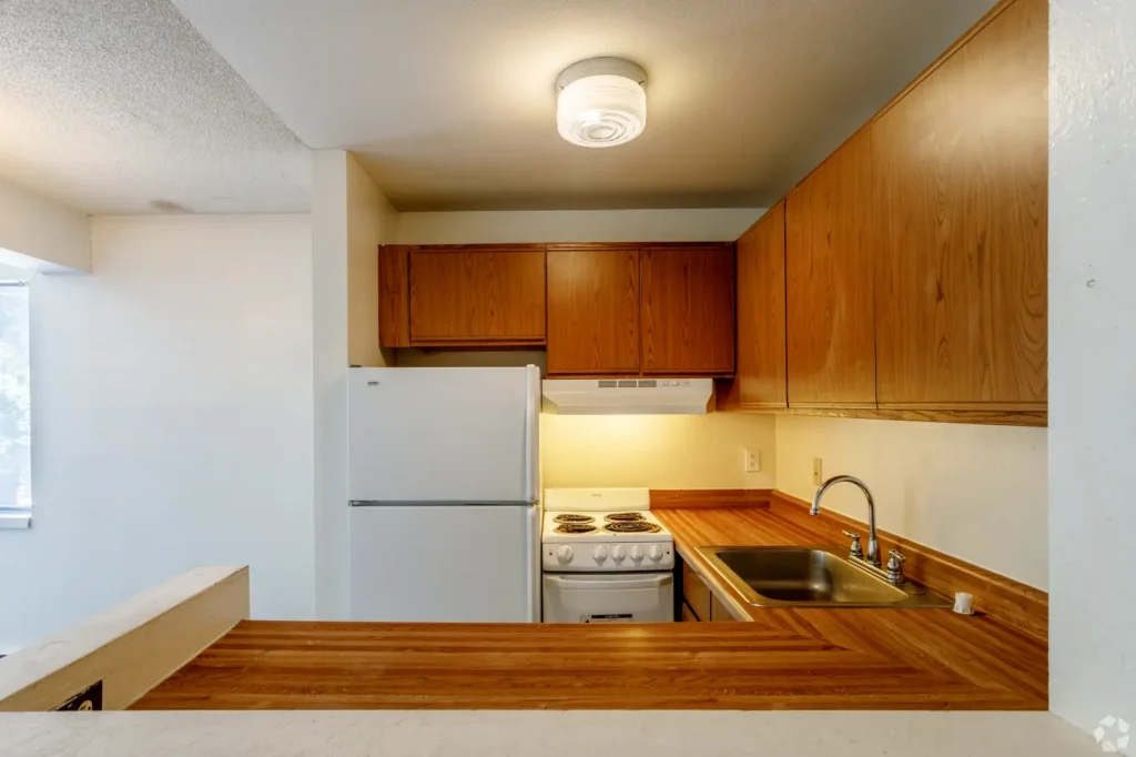 Kitchen with wood cabinetry at Creekside Apts, apartments in Boulder, Colorado for students