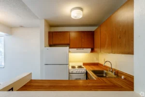 Kitchen with wood cabinetry at Creekside Apts, apartments in Boulder, Colorado for students